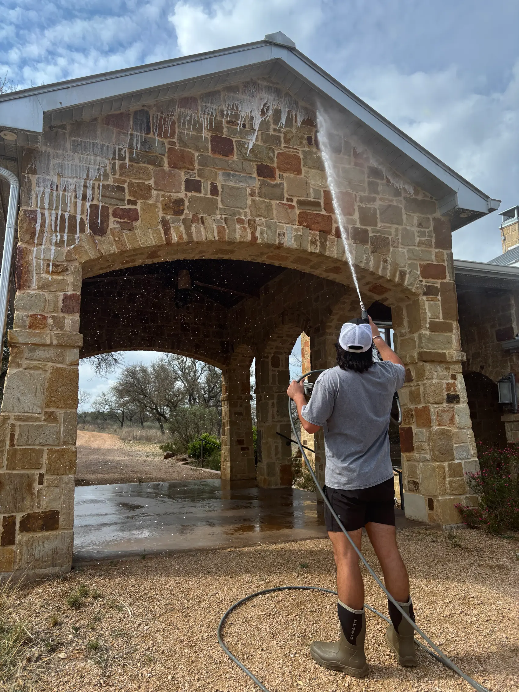 SudZup pressure washing a Texas stone home
